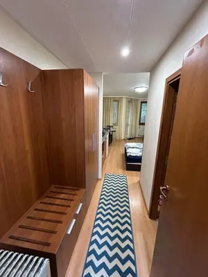 a room with a hallway with a bed and a rug at Studio Villa Park 119 in Borovets
