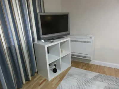a living room with a television on a white cabinet at Apartment Sofia Center 2 in Sofia