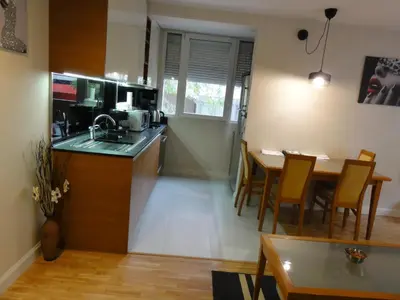 a kitchen and dining room with a table and a kitchen and a dining room at Apartment Sofia Center 2 in Sofia