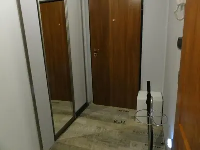 a hallway with a mirror and a refrigerator in a room at Apartment Sofia Center 2 in Sofia