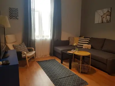 a living room with a couch and a table at Radomir Downtown Apartments in Radomir