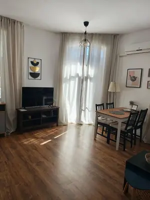 a living room with a table and a dining room at Radomir Downtown Apartments in Radomir