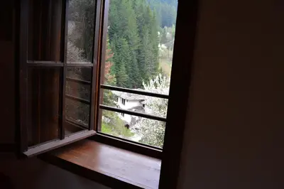 an open window with a view of a forest at Къща за гости Гайтана in Shiroka Lŭka