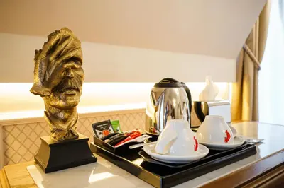 a table with a tea kettle and two cups on it at Residence City Garden - Certificate of Excellence Top 10 BEST Five-Stars City Hotels for 2024 awarded by HTIF in Plovdiv