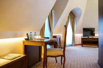 a hotel room with a desk and a television at Residence City Garden - Certificate of Excellence Top 10 BEST Five-Stars City Hotels for 2024 awarded by HTIF in Plovdiv