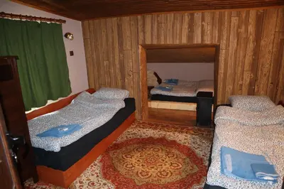a bedroom with two beds and a mirror at Roots Apartment in Borovets