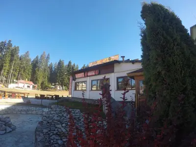 a building with a sign on top of it at Roots Apartment in Borovets