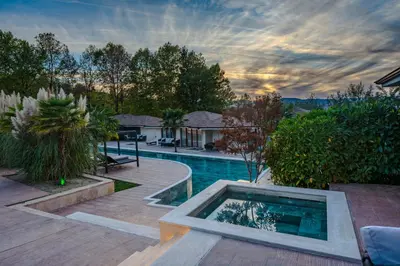 a backyard with a swimming pool and a house at Medite Spa Resort and Villas in Sandanski
