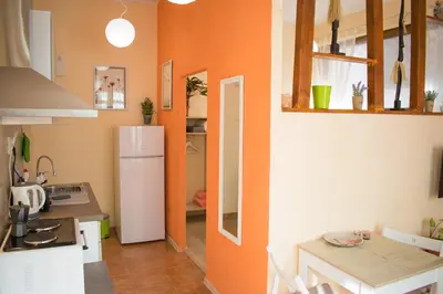 a kitchen with an orange wall and a white refrigerator at 4 Seasons apartments, A1 in Plovdiv