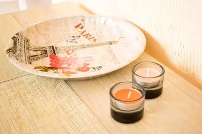 two candles and a plate on a table at 4 Seasons apartments, A1 in Plovdiv