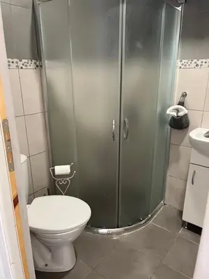 a bathroom with a shower with a toilet and a sink at Vel House in Plovdiv