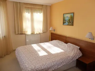 a bedroom with a bed and a window at Borovets Apartment, Villa Park in Borovets