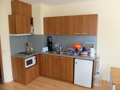 a kitchen with wooden cabinets and a white refrigerator at Borovets Apartment, Villa Park in Borovets