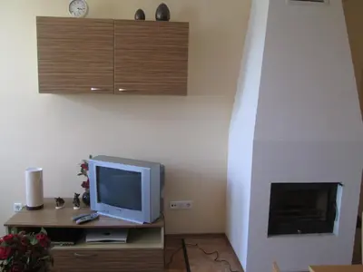 a television sitting on a table in a room at MD Alexander Services Apartments in Bansko