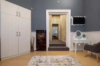 a living room with blue walls and a door with a stairway at Temptation in Sofia - 24h Self Check-in in Sofia
