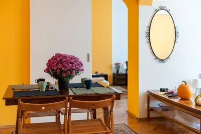 a dining room with a table and a mirror at Vitosha Blvd - Family and Friends Apart in Sofia
