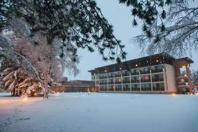 a building with snow in front of it at Belchin Garden SPA&Wellness in Belchin