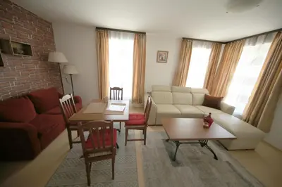 a living room with a couch and a table at Great location near lift in Bansko
