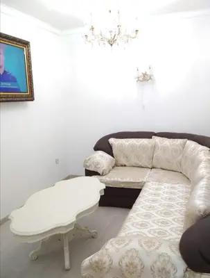 a living room with a couch and a table at Ikonomov House in Bansko
