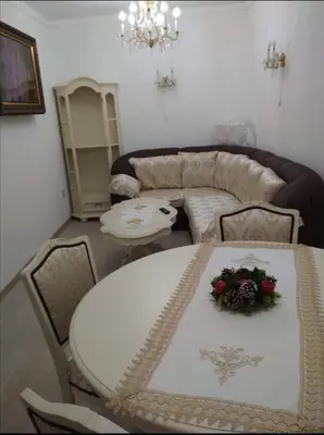 a living room with a white table and chairs at Ikonomov House in Bansko