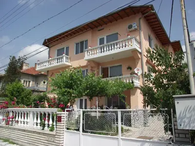 a house with a white fence in front of it at Family Hotel Velevi in Velingrad