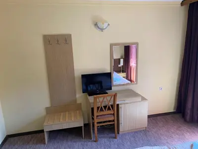 a room with a desk with a television and a mirror at Iglika Bansko in Bansko