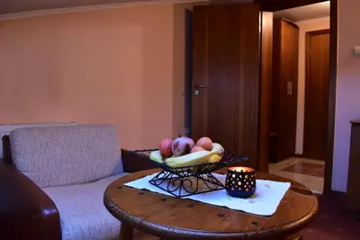a bowl of fruit on a table in a living room at Family Hotel Bashtina Kashta in Koprivshtitsa