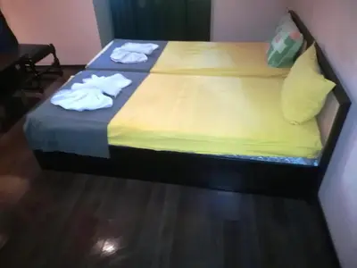 a bedroom with a bed with towels on it at Hotel Trakart Residence in Plovdiv