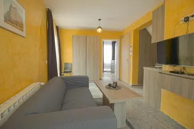 a living room with a couch and a television at Mini Sofia in Sofia