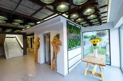 a room with a vase of sunflowers on a table at HOTEL FINIX CASINO in Kulata
