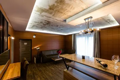 a living room with a ceiling with a painting on it at HOTEL FINIX CASINO in Kulata