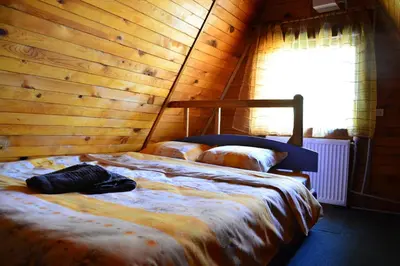 a bedroom with a bed in a wooden wall at Borovets Gondola Apartment & Ski by Winter Bros in Borovets