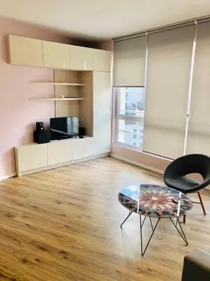 a living room with a table and a chair at Bluemarine Apartment in Sofia