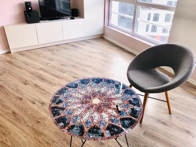 a living room with a chair and a table at Bluemarine Apartment in Sofia