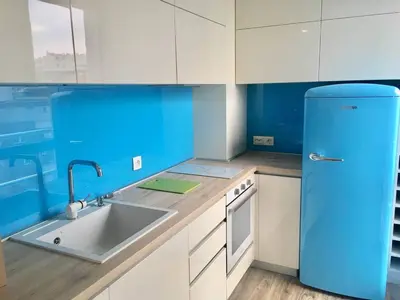 a blue refrigerator in a kitchen with a sink at Bluemarine Apartment in Sofia