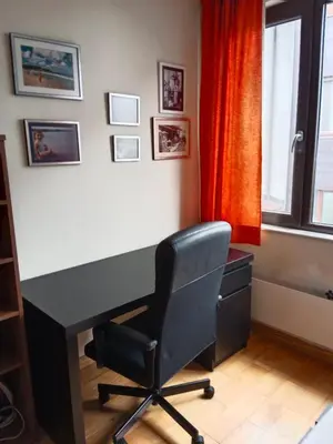 a desk and a chair in a room with a window at Mountain Escape Bansko 1BR apartment in Bansko