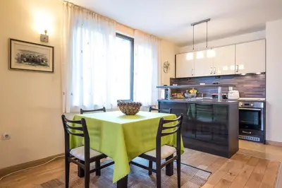 a kitchen with a table and chairs and a kitchen with a counter at Mountain Escape Bansko 1BR apartment in Bansko