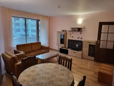 a living room with a couch and a table at Evrika Forest in Pamporovo