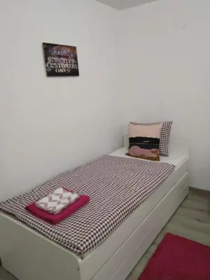 a bedroom with a bed with pink and white sheets at Sofia Peak in Sofia