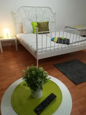 a living room with a bed and a remote control at Sofia Peak in Sofia