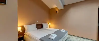 a bedroom with a bed with two towels on it at Balkan Hotel in Chiflik