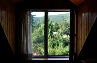 an open window with a view of a mountain at Strandzhata's House in Pasarel