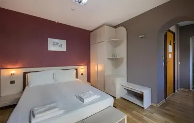 a bedroom with a bed with two towels on it at Family Hotel Zornitsa in Ribarica