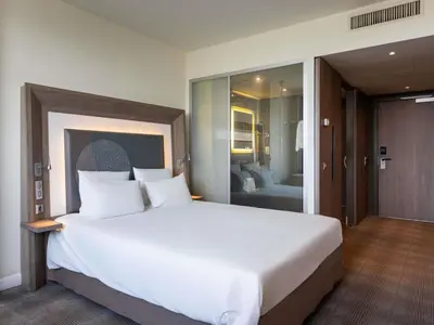 a large white bed in a hotel room at Novotel Sofia in Sofia