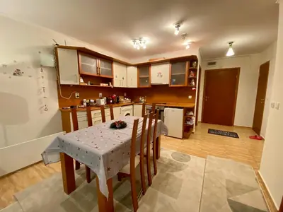 a kitchen with a table and chairs and a kitchen with a refrigerator at Aparthotel - Monastery 3, 1 Bedroom Apartment in Pamporovo