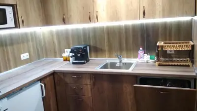 a kitchen counter with a sink and a microwave at Боримечковата къща in Kalofer