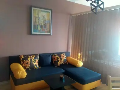 a living room with a blue couch and a table at F307 Studio Aspen Golf Resort Bansko in Bansko