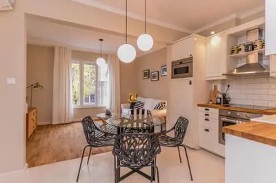 a kitchen and dining room with a table and chairs at cО́coEllie - Aesthetic 2BD Apt Near National Palace by Flat Mаnager in Sofia