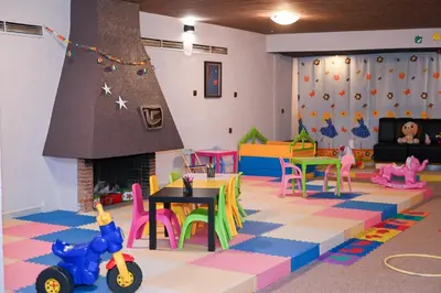 a play room with a fireplace and toys in it at Hotel Borovets Edelweiss in Borovets