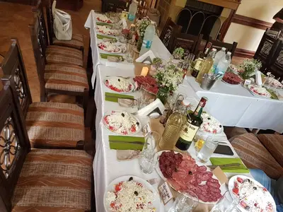 a long table with plates of food and bottles of wine at Family Hotel Fedora in Ribarica